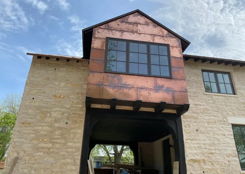 Copper metal panel facade on a stone building for Skylight Installation in Albertville