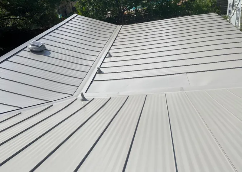 Solar attic fan installed on a metal roof for Roof Ventilation in Albertville
